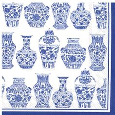 blue and white vases are on a napkin