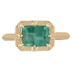 Introducing a captivating solitaire emerald ring that exudes charm and grace. This stunning piece features an approximate 1.75-carat natural emerald cut emerald, delicately set east to west in an elegant 8 prong setting. The emerald boasts a beautiful light spring green color, evoking a sense of freshness and vitality. Its unique characteristics add a touch of individuality and charm to the ring. Crafted with meticulous attention to detail, the ring is set and crafted in 14k gold, showcasing a harmonious blend of sophistication and beauty. Setting Style: Prong-Solitaire Setting Material: 14K Yellow Gold Main Stone: Emerald Shape: Emerald Cut Approx Weight: 1.75-Carats Measurements: 8mm x 6mm Clarity: Semi-Transparent Color: Spring Green Luster: Very Good Treatments: Natural, Oiling Origin: Spring Green Color, Smaragd Ring, Emerald Gem, Ladies Ring, Minimalist Gifts, Unique Characteristics, Light Spring, Ring Light, Emerald Earrings