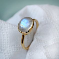 Rainbow Moonstone gold ring, 14k yellow gold Moonstone ring, Moonstone jewelry, beautiful gold ring, gift for her, Oval cabochon stone The 14K yellow solid gold bezel and solid yellow gold ring are both shined to an extremely high polish. All rings are packaged and shipped in a beautiful ring box. The main stone is natural, fire, Rainbow Moonstone. Gemstone Size Approx : 10 x 8 mm The pictures have been enlarged to show the details. The price is for a 14k gold ring, if you want to order the ring Yellow Gold Moonstone Ring, Beautiful Gold Rings, Gold Moonstone Ring, Cocktail Jewelry, Artisan Rings, Blue Moonstone, Moonstone Engagement Ring, Girl Jewelry, Rainbow Moonstone Ring