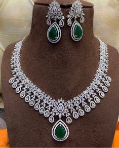 This absolutely stunning and elegant necklace set comes with dark green and white cubic zirconia encrusted stones on a silver base. This set come with necklace and earrings. Absolutely beautiful snd a must have. Would make a lovely anniversary or valentines gift.  This eye catching unique ethnic jewellery set is ideal for any traditional attire  Wear this with a saree , party wear on any festival or special occasions. This piece is readily available for immediate dispatch. Please note as this is Exquisite Green Diamond Necklace, Wedding Silver Emerald Necklace With Cubic Zirconia, Wedding Silver Emerald Cubic Zirconia Necklace, Silver Diamond Bridal Necklace With Gemstone, Formal Silver Jewelry Sets With Emerald, Silver Cubic Zirconia Necklace With Stone Setting, Formal Silver Emerald Jewelry Sets, Silver Emerald Necklace Brilliant Cut For Wedding, Cubic Zirconia Emerald Necklace In White Gold For Weddings