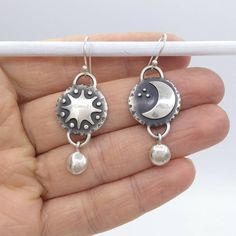 These Sun and Moon Earrings symbolize the harmony and union of opposites. The Sun being the Masculine while the moon being the feminine and representing a calm. They invoke feelings of ~Balance and ~Completeness. I design and fabricate each earring myself, so this is a piece that you won't see on many people. Made of high quality recycled, eco friendly solid sterling silver. Designed and handmade in the USA. Silver Crescent Symbolic Earrings, Symbolic Silver Crescent Earrings, Unique Sun And Moon Design Drop Earrings, Silver Symbolic Crescent Earrings, Unique Moon Phase Earrings For Gift, Unique Sun And Moon Design Earrings As Gift, Adjustable Sun And Moon Sterling Silver Earrings, Handmade Moon-shaped Spiritual Earrings, Adjustable Sterling Silver Sun And Moon Earrings