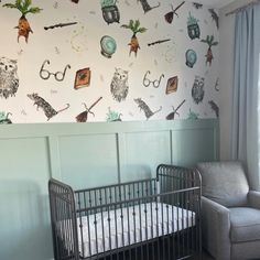 a baby's crib in the corner of a room with wallpaper on it