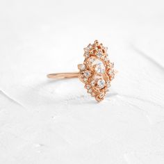 Round rose cut diamond focal: 3mm, SI clarity. This design features a closed basket setting on a delicate 1.2mm band—available in 14k solid yellow, white or rose gold. The setting is accented by twenty-five (1-2.2mm) round white diamonds. All accent diamonds are SI clarity and G+ color. We handcraft each piece with responsibly sourced 14k gold and ethically sourced stones. Heirloom Crystal Ring With Rose Cut Diamonds, Heirloom Rose Cut Diamond Promise Ring, Delicate Crystal Ring With Rose Cut Diamonds For Wedding, Delicate Rose Cut Diamond Crystal Wedding Ring, Delicate Crystal Wedding Ring With Rose Cut Diamonds, Fine Jewelry Wedding Diamond Ring With Rose Cut Diamonds, Elegant Rose Gold Crystal Ring With Rose Cut Diamonds, Heirloom Rose Gold Diamond Ring With Intricate Design, Heirloom Wedding Cluster Ring With Rose Cut Diamonds