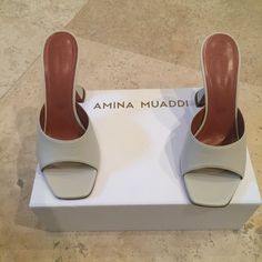 New, Never Worn, In Original Box Amina Muaddi Lupita Slipper Sandals In Size 39 - Rare Color And Sold Out Everywhere! - Brand Calls This Color Dirty Ice - It Is A Bone / Beige Color. - Leather Upper And Sole - Made In Italy - Approx 100mm/ 4 Inch Sculptural Heel - Square Toe - Original Box And Dustbag Included White Mules With Branded Heel Counter For Summer, White Spring Mules With Branded Heel, White Open Toe Mules With Contrasting Heel Counter, Modern White Sandals With Contrasting Heel Counter, White Closed Toe Mules With Padded Heel, White Mules With Contrasting Heel Counter And Closed Toe, White Closed Toe Mules With Heel Strap, White Mules With Contrasting Heel And Closed Toe, White Mules With Wrapped Heel And Round Toe