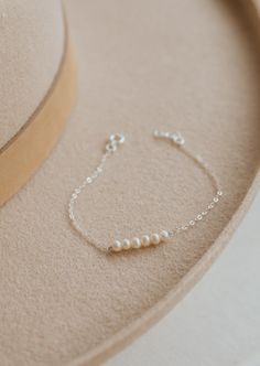 The bracelet version of our Pearl Linked Necklace. Let each of these pearls symbolize something special in your life. Use it as a daily reminder to count your blessing. 2-7 pearls are attached to our dainty cable chain. Bracelet is adjustable from 6.5 - 7". Available in 14kt Gold Fill + Sterling Silver. Layered with our Birdie Initial Bracelet. Handmade in Eau Claire, WI. Our jewelry is handmade so each piece will be unique and may vary slightly from what is pictured. Handmade Chain Bracelet, Handmade Pearl Bracelets, Pearl Bracelets Ideas, Pearl Jwellary, Pearl Jewelry Aesthetic, Silver Beaded Jewelry, Diy Jewelry Set, Linked Bracelet, Silver Pearl Bracelet