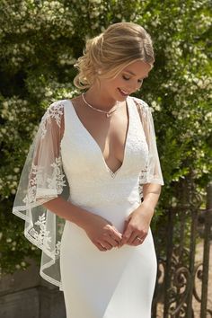 a woman in a white wedding dress and veil