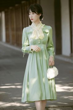 Radiate an air of sophistication in this dress that takes inspiration from the Edwardian period. It features a high collar neckline with delicate floral embroidery, lace frills and attached neck-piece. For added elegance, the shoulder seams are slightly puffed, and waistline sits on the upper-waist. Sleeves are cuffed with lace and three button closures, plus a ribbon detail. The dress has a buttoned front closure and concealed side zipper for ease of wear. It is made with a silky satin fabric a Dress Mint, Neck Piece, Embroidery Lace, Overall Dress, Sweater Blouse, Cardigan Jacket, High Collar, Cute Fashion, Satin Fabric