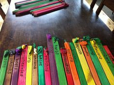 a group of colorful sticks sitting on top of a wooden floor next to each other