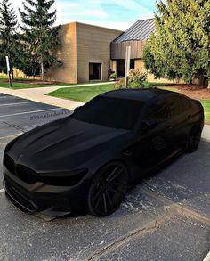 a black car parked in front of a building