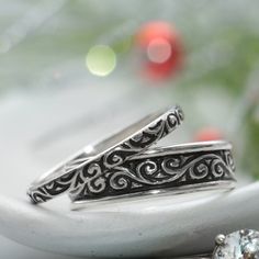 "This Sterling Silver Matching Couples Ring Set has a beautiful curling pattern that continues around the length of both the wide and narrow band. We are happy to create this beautiful band set for you in a variety of ring sizes and finish options! For the Narrow Band: This delicate and narrow Sterling Silver Smoke Swirl pattern band has a beautiful, curling design that is a wonderful compliment for everything from filigree to modern styles. It measures 2.5 mm (about .1 inch) in width and is 1.5 Anniversary Filigree Toe Ring, Wedding Rings With Intricate Design, Engraved Toe Ring Jewelry For Wedding, Engraved Toe Ring For Wedding, Handmade Wedding Couple Rings, Wedding Stackable Rings With Decorative Adjustable Band, Adjustable Filigree Ring With Intricate Design For Wedding, Sterling Silver Band With Intricate Design For Gift, Anniversary Sterling Silver Stackable Rings With Intricate Design