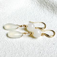 Discover the serene beauty of our White Jade and White Chalcedony Gold-Filled Earrings. Combining the smooth, calming energy of 8mm white jade with the soft, ethereal glow of a 15mm white chalcedony, these earrings exude timeless elegance. These earrings are approximately 48mm in length. Customisation Personalise your earrings by choosing your preferred metal! Simply send me a message, and I'll tailor your pair at no extra cost, ensuring they match your vision perfectly. Packaging Each pair arri White Dainty Earrings For Jewelry Making, White Drop Earrings For Pierced Ears, White Teardrop Earrings As Gift, White Dangle Earrings For Anniversary, White Drop Earrings Gift, White Drop Earrings For Anniversary, White Drop Earrings For Gift, White Dainty Earrings For Anniversary, Dainty White Earrings For Anniversary