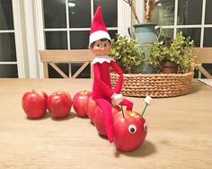 an elf is sitting on top of apples