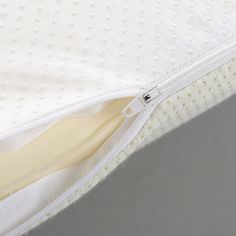 closeup of the zipper on an unmade mattress with no sheets or pillows in it