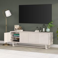 an entertainment center with a large flat screen tv mounted on it's sideboard