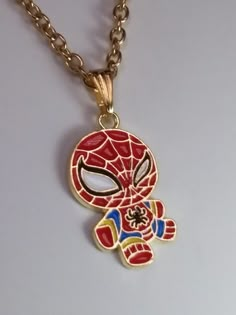 a spiderman necklace is shown on a chain