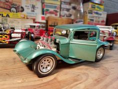 toy cars are lined up on a wooden table