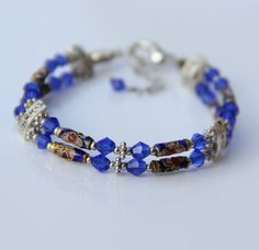 The bracelet is handmade using cloisonne and Czech crystal glass. The splendor of cloisonne will awe you with with its intricate pattern and the brilliant colors. The indigo blue is a very classic color for Chinese cloisonne. The length of the bracelet is 7-8 ¼ inches, 18-21cm. For matching earrings, please go to: https://www.etsy.com/listing/118477802/earring For matching necklace, please go to: https://www.etsy.com/listing/118477769/necklace ;-) Enter my shop here: http://www.etsy.com/shop/Ani Czech Glass Round Jewelry Gift, Round Czech Glass Jewelry Gift, Adjustable Czech Glass Bracelets For Gifts, Adjustable Czech Glass Bracelets As Gifts, Adjustable Czech Glass Bracelet As Gift, Nickel-free Czech Glass Jewelry Gift, Nickel Free Round Beaded Bracelets As Gift, Nickel-free Round Beaded Bracelets For Gift, Nickel-free Round Beaded Bracelets As Gift