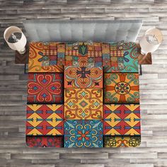 an overhead view of a room with wood flooring and colorful tiles on the wall