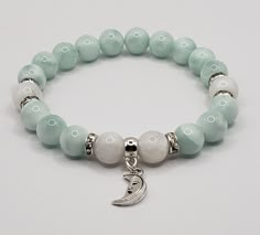 "High quality, genuine, Natural, AAA grade green moonstone bracelet, combined with white moonstone beads and crystal rondelle spacers and a moon charm. I didn't know green moonstone exist in a natural form, when I found out about this beauty, I had to make a green moonstone bracelet.. :) Such a beauty and so elegant! It's real and natural so that light green /mint color is it's natural color, not treated or dyed in any way. The white moonstone beads are also natural and high quality.. Made with White Jade Crystal Healing Bracelet, White Jade Crystal Bracelet For Healing, White Jade Crystal Bracelet, White Jade Crystal Bracelet With Natural Stones, Green Moonstone, Bracelets Charm, Moon Bracelet, Diy Bracelet Designs, Beads Bracelet Design