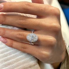 a woman's hand with a diamond ring on it