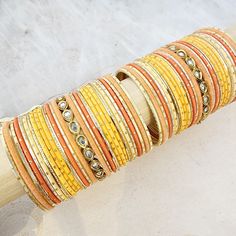 Beautifully designed bangles for any occasion. South asian bracelets come in a variety of styles, colors, and finishes. We at Banglez take creating the perfect bangle set for you to another level! You could say helping you find your favorite stack of bangles as one of our greatest missions. This bangle set was curated in house by one of our talented team members. We hope you love them as much as we do! Bohemian Stackable Wedding Bracelets, Adjustable Yellow Round Bangle, Stackable Fusion Style Bangle Bracelets, Adjustable Round Cuff Bracelet For Festive Occasion, Orange Bracelet For Festivals As Gift, Orange Bracelets For Festivals Gift, Orange Bracelets As Festival Gifts, Bohemian Orange Bangle Jewelry, Orange Festival Bracelet As Gift