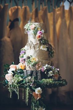 a three tiered wedding cake with flowers on the top is displayed in an instagram