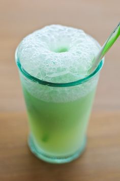 a green drink with a straw in it