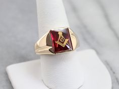 "This vintage red ruby glass Masonic ring features polished, structurally simple shoulders, and a simple rectangular shape. The center is a classic red ruby glass cabochon, inlaid with the gold Masonic symbol, with a nice flat profile. Metal: 10K Yellow Gold Gem: Ruby Glass Gem Measurements: 12.0 x 10.1 mm, Rectangle Ring Size: 12.50 Marks: \"10K\" Stamped on the inside band SKU #: NALNWC2H Each piece has been identified and graded by a Graduate Gemologist who has been certified by the Gemologic Masonic Symbol, Mens Vintage Jewelry, Gem Ruby, Rectangle Ring, Masonic Symbols, Right Hand Ring, Masonic Ring, Best Flats, Cameo Ring