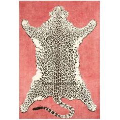 an animal print rug is shown on a pink background with black and white spots in the shape of a man's torso