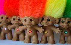 there are many small toy trolls with different colors on their heads and the words don't feed them