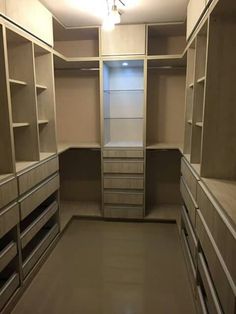 an empty walk in closet with lots of drawers