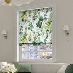 a living room with a couch and window covered in green floral fabric covering the windows