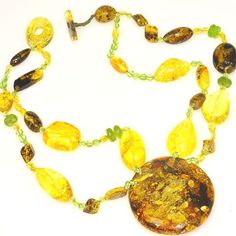 Necklace Stone(s): Genuine Baltic honey amber, Baltic citrine amber and genuine peridot (pendant amber measures 2.25 x 2 x 0.7 inches) Necklace Length: 18 inches Deep: 2.25 inches Weight: 77.5 grams Clasp: Toggle Stamp/Mark: N/A Origin: Poland Serial Number: n20382 Amber, an organic gemstone, is the fossilized resin of prehistoric trees which grew up to 50 million years ago. The stone has been used for jewelry since the time of Christ. The world's finest amber comes from the region around the Ba Prehistoric Trees, Silicate Minerals, Peridot Pendant, Peridot Necklace, Necklace Stone, Green Peridot, Necklace Length, Stone Necklace, Citrine