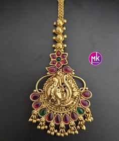 Peacock design Antique gold finish AD stone with gold ball hanging hangings Tikka/Nethichutti -  MK Fashionkart - Indian Fashion Jewelry Material:  Antique gold finish with AD stone Suitable for Saree/Salwar/party wear dresses   SHIPPING : Ready to ship in 1 business day. This item will be shipped from The United States. Jewelry care instructions : 1. Please wipe the jewelry with a piece of cotton cloth after usage.  2. Store the jewelry in a cool, dry and air tight box or pouch.  3. Make sure the jewelry is away from direct heat and water. 4. Please wipe of any moisture, sweat, soap water after usage. Gold Temple Jewelry Tikka For Celebration, Gold 22k Chandbalis With Peacock Design, Gold Chandbalis With Peacock Design In 22k Gold, Gold Temple Jewelry Tikka With Stone Work, Gold Kundan Chandbalis With Peacock Design, Gold Tikka With Latkans Temple Jewelry, Gold Chandbalis With Peacock Design For Festivals, Gold Chandbalis With Peacock Design For Ceremonial Events, Gold Chandbalis With Peacock Design For Ceremonial Occasions