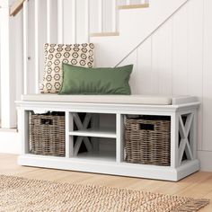 a white bench with baskets under the stairs