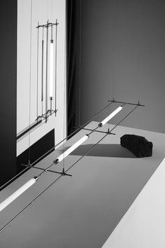 a black and white photo of a mirror with some lights hanging from it's sides