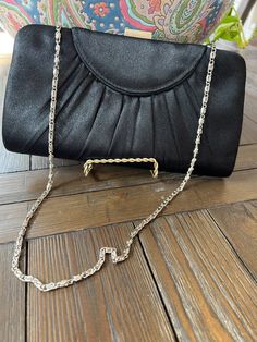 "This evening bag is 100% polyester & made in China. It is in good condition & has one open interior pocket. This bag can fit most cell phones. Perfect for your black tie affair or date night!  Size  8 3/4\" wide x 4 1/2\" tall" Elegant Evening Bag With Chain Strap For Night Out, Chic Satin Evening Bag For Formal Occasions, Formal Satin Evening Bag With Satin Lining, Elegant Satin Evening Bag For Formal Occasions, Elegant Satin Finish Evening Bag For Formal Events, Elegant Satin Finish Evening Bag For Formal Occasions, Elegant Satin Evening Bag, Satin Evening Bag With Satin Lining, Elegant Formal Bags With Satin Lining