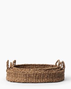 an empty basket with rope handles on a white background