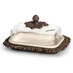 a cake dish with a glass cover on it