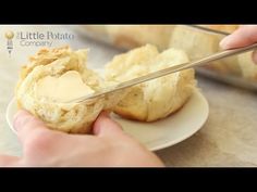 someone is cutting into some bread on a plate