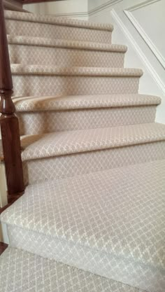 an image of a set of stairs with carpet on the bottom and bottom treads