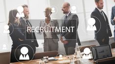 a group of business people standing around a conference table with the word recruit on it