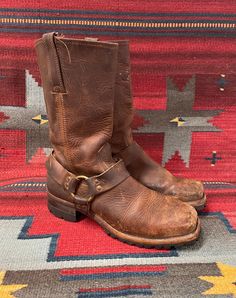 From Blackbird Vintage of Sedona, Arizona  This is a great pair of brown leather Vintage Frye Square toe harness Moto boots, Men's size 10.5,  circa 1990's.  They feature chunky long lasting Vibram lug soles! These great boots have a 1.75" heel and are 13" Tall.  They have a fantastic patina! They are in distressed and broken-in vintage condition. They are very well-made and have lots of life left! Condition Notes: -Worn, broken in, and distressed with scuffing, soiling, staining -Appears to be Western Brown Moto Boots With Buckle Closure, Western Style Brown Moto Boots With Buckle Closure, Vintage Brown Leather Moto Boots, Rugged Style, Vintage Brown Rugged Leather Moto Boots, Rugged Distressed Brown Snip Toe Moto Boots, Rugged Distressed Brown Moto Boots With Snip Toe, Rustic Vintage Brown Leather Moto Boots, Rustic Moto Boots With Leather Sole In Oiled Leather, Rustic Moto Boots With Oiled Leather