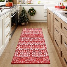 a red rug in the middle of a kitchen with christmas decorations on the counter top