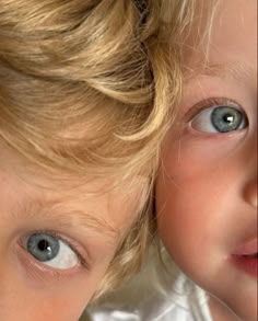 two young children with blue eyes and blonde hair