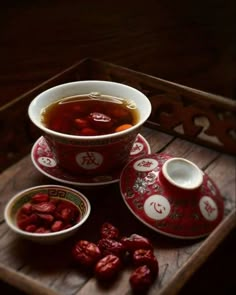 there is a bowl of tea and two bowls of gourmet food