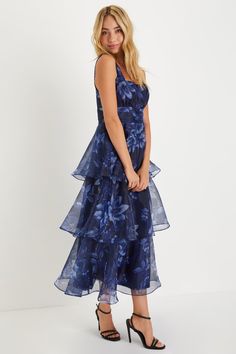 Everyone will be wowed when you walk in wearing the Lulus Dramatic Glamour Navy Blue Floral Organza Tiered Midi Dress! Airy woven organza boasts a moody floral print as it shapes wide tank straps and a square neckline. Banded waist boasts chic gathered details, atop a voluminous tiered skirt that falls to a long midi hem. Hidden zipper/clasp at side. Fit: This garment runs small - please size up. Length: Mid-calf length. Size medium measures 50.5" from shoulder to hem. Bust: Works best for A to Organza Prom Dress With Floral Print, Organza Floral Print Prom Dresses, Floral Print Organza Prom Dress, Floral Print Organza Dresses For Prom, Blue Organza Dress For Wedding Guest, Elegant Floral Dress With Ruffles For Evening, Elegant Floral Ruffle Dress For Evening, Floral Print Organza Dresses For Garden Party, Organza Floral Print Garden Party Dress