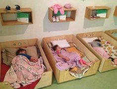 three children sleeping in wooden beds with pink blankets