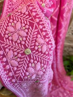 A very very pretty Chikankari saree in pure georgette in a lovely candy pink shade with all over jaal (barfi pattern) embroidery with mukaish work (embellishments). The pallu is short but features intricate designs. The entire saree has the same pattern from the very beginning of the saree except the portion you have to tuck in so that it doesn't bulge. Entire saree is framed in cord piping, best quality satin falls are attached and picot stitching is done as well. The blouse piece is separated Pink Pre-draped Saree With Motifs, Festive Pink Pre-draped Saree With Motifs, Navratri Pink Pre-draped Saree With Intricate Embroidery, Pink Anarkali Pre-draped Saree With Intricate Embroidery, Festive Pink Saree With Intricate Embroidery, Unstitched Pink Blouse Piece With Intricate Embroidery, Pink Semi-stitched Saree With Intricate Embroidery, Pink Georgette Traditional Wear With Cutdana, Pink Intricate Embroidery Designer Pre-draped Saree