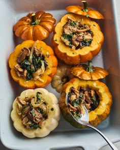 stuffed pumpkins with mushrooms and spinach in a baking dish, ready to be eaten